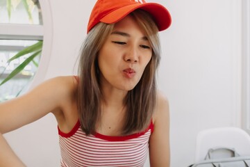 Portrait of cute asian girl in red wearing red hat.