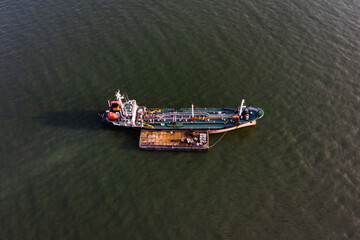 Aerial view of the oil and gas tanker cargo ship with isolated greenish sea