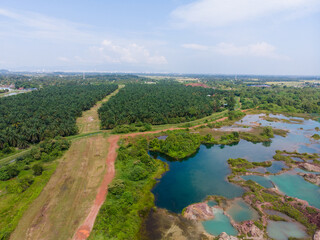 Fototapeta na wymiar Aerial view of a small laterite mountain with a lots of small lake that reflect the sky colour.
