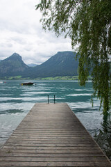 wooden pier on the lake with a view of the mountains