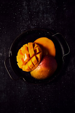 Fresh Mango on black tray and black background