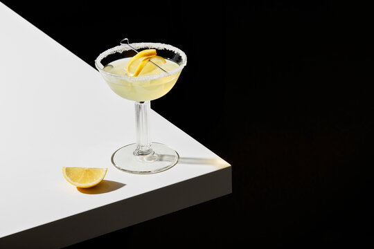 Lemon Cocktail on a White Table and Black Background