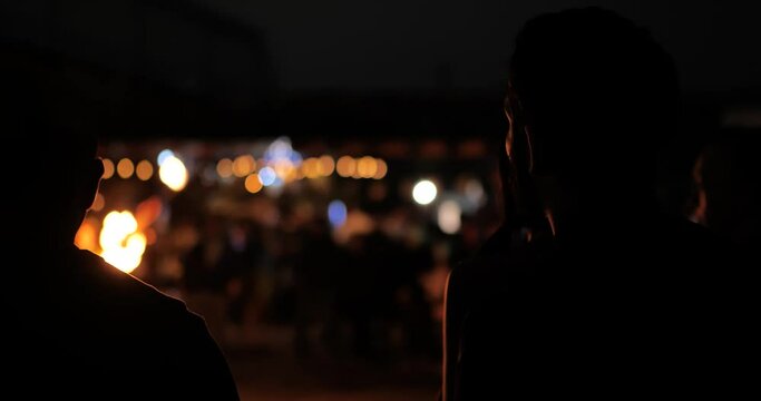 Man looking at fire show back of man
