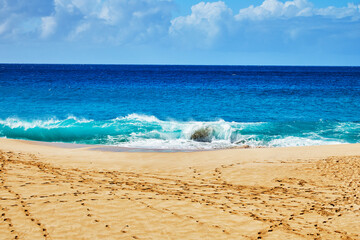 Ocean waves breaking onto a sand beach