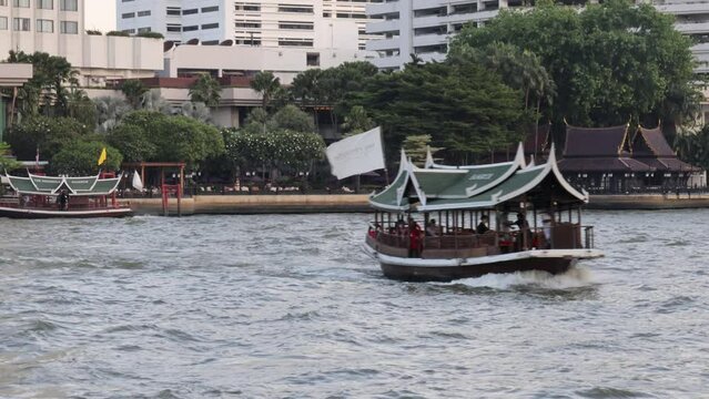 Bangkok, Thailand. December 29, 2022. Ferry boat moving on Chao Phraya river in Bangkok.