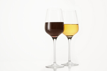 Two wineglasses half filled with red and white wine.