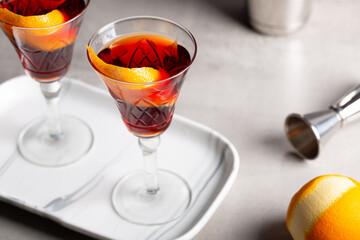 Boulevardier cocktail boozy bourbon whiskey, bitter and sweet vermouth with orange peel as garnish