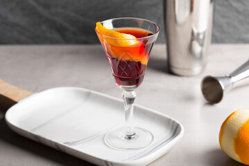Boulevardier cocktail boozy bourbon whiskey, bitter and sweet vermouth with orange peel as garnish