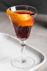 Boulevardier cocktail boozy bourbon whiskey, bitter and sweet vermouth with orange peel as garnish