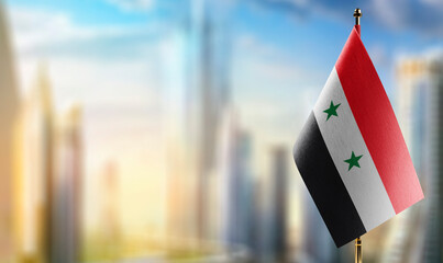 Small flags of the Syria on an abstract blurry background