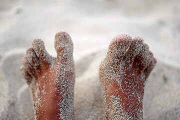 foot on the sand with blurred background