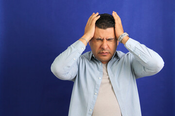 Forty year old brown latino adult man suffering from migraine disease headache, depression and...