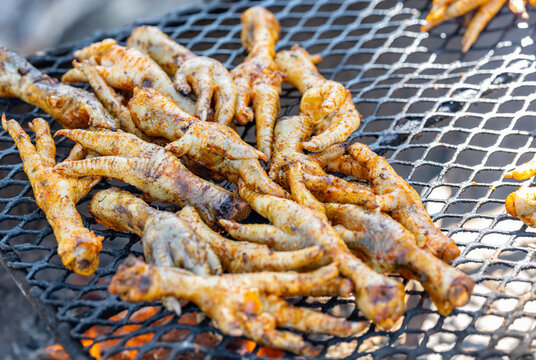 Grilled chicken feet on a charcoal grill in the township of Langa near Cape Town