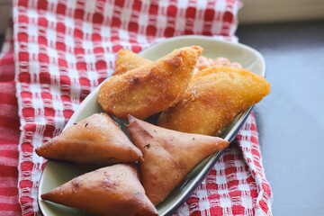 Samoosas and halfmoons on a plate