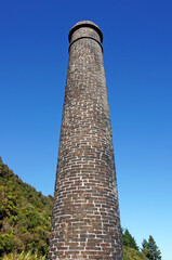 Large brick chimney against a blue sky at historic Brunner Coal Mine