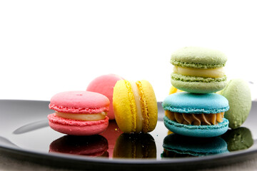 Colorful macaroons stacked on white background. High quality photo