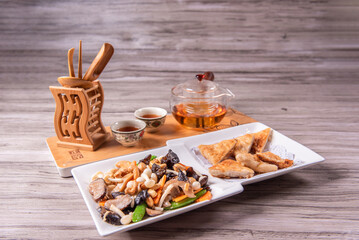 stir fried white shimeji mushroom with scallop black fungus cashew nut deep fried yam bean curd and mixed colourful vegetables on wood table asian Chinese vegan halal food banquet menu for restaurant