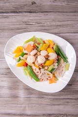 stir fried white shimeji mushroom with scallop black fungus cashew nut deep fried yam bean curd and mixed colourful vegetables on wood table asian Chinese vegan halal food banquet menu for restaurant