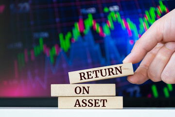 Wooden blocks with words 'RETURN ON ASSET'. Business concept