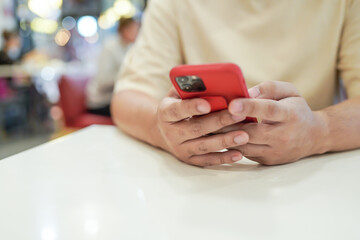 Relaxed young asian man using smart phone  spending time checking news social media.