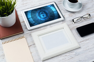 Web security and technology concept with tablet pc on wooden table