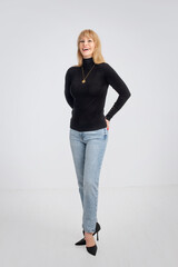 Full length of an attractive middle age woman against white background