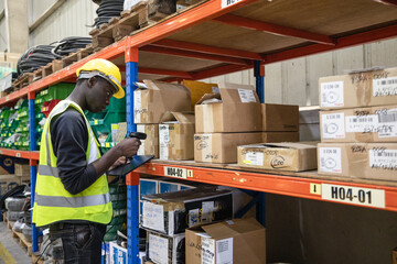 Warehouse worker tag and label products with a handheld scanner to prepare and complete orders. Verifying all products are safely and securely packed and labeled for shipment to the correct location.