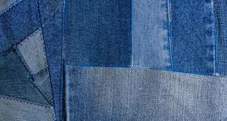 Old denim jeans texture or background made from different colored jeans peaces.	