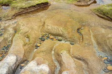 colored pebbles under water