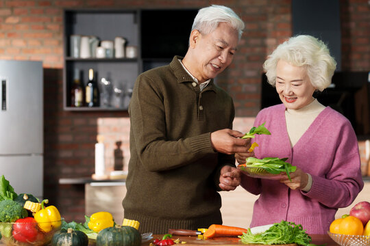 Elderly couple in the kitchen cooking