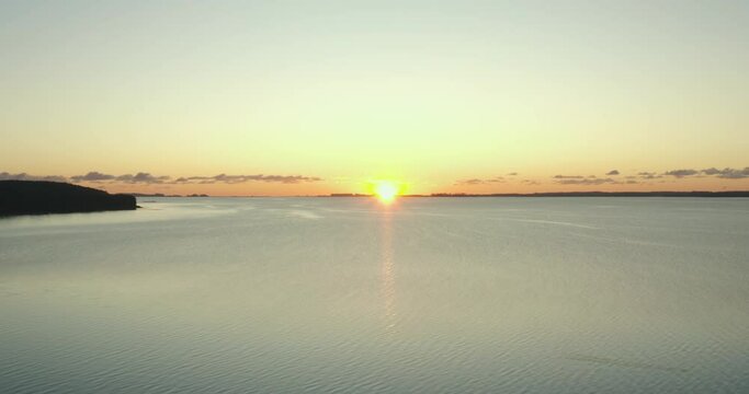 AERIAL: Drone footage of sunrise over a lake in Denmark.