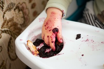 young child enjoying eating marmalade / jam / jelly
