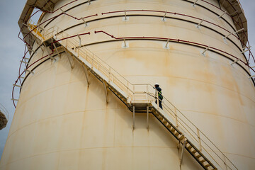 Obraz premium Male walking the up stairway inspection visual tank.