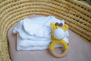 basket there are things for the baby and wooden and knitted toys-rattles. Natural natural minimalistic style. View from above - 591758613