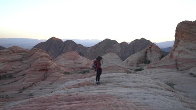 Woman With Backpack Taking Photos of Rock Formations in Utah USA. Yant Flat, Candy Cliffs USA