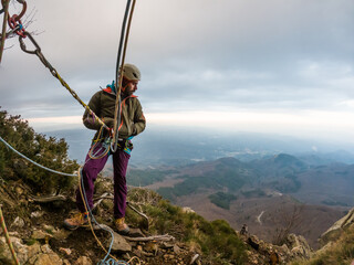 man climbing at sunset in the mountains with the forest in the background, copy space, business, security, trust