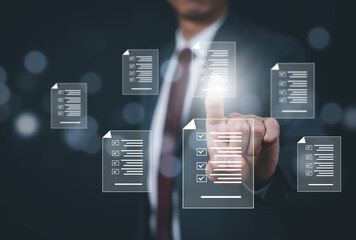 Business people hand touch Online documentation database, complete the online survey form, answer the test questions. Marked checklist on a clipboard. Human resources and management concept, BigData