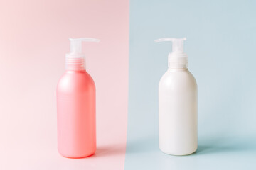 Tubes with dispenser against pink and blue background.