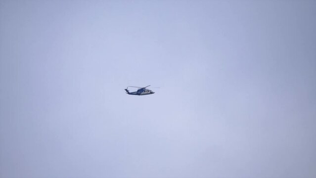 Distant Helicopter Flying, Sky Background, Tracking Shot.