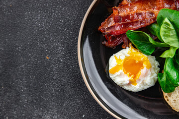 poached egg breakfast bacon, green leaves salad mix meal food snack on the table copy space food background rustic top view
