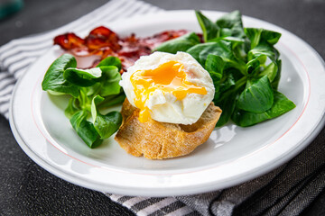 poached egg breakfast bacon, green leaves salad mix meal food snack on the table copy space food background rustic top view