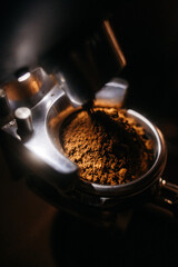 Coffee grinder grinding coffee beans for espresso