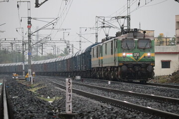 the indian train moving on railway track with white sky