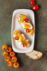 Open sandwiches with egg and tomatoes in a plate on the table
