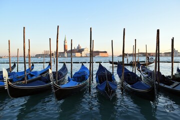 Fototapeta na wymiar Canoes on the pier of the Venetian Canal during the Venice Festival