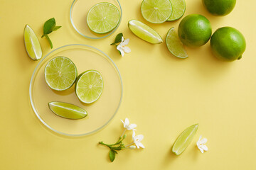 A round transparent podium and glass petri dish decorated with Lime slices and small flowers. Copy...
