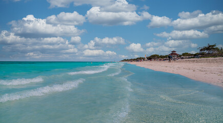 Turquoise blue Atlantic waves and blue sky with white clouds on Varadero beach.
