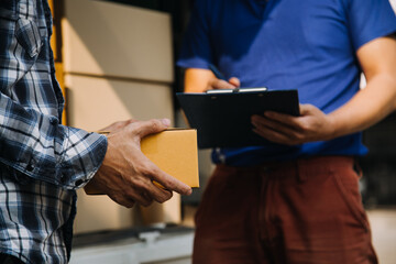 Startup SME small business entrepreneur of freelance Asian woman wearing apron using laptop and box to receive and review orders online to prepare to pack sell to customers, online sme business ideas.