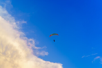 Paraglider in blue sky and big cloud