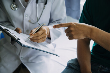 close up of patient and doctor taking notes